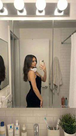 Petra - ASYMMETRIC TEXTURED BLOUSE - LIMITED EDITION + 50TH ANNIVERSARY LEATHER TROUSERS WITH DARTS AND BELT - Bathroom Mirror Selfie [Rotated 39° Left]